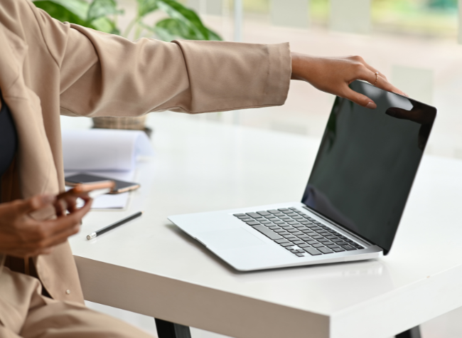 woman closing a laptop