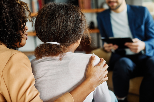 image of an adult with her child being interviewed