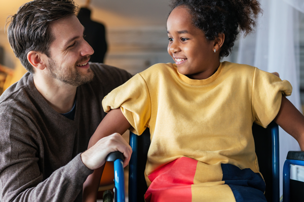 a man with a child in a wheelchair